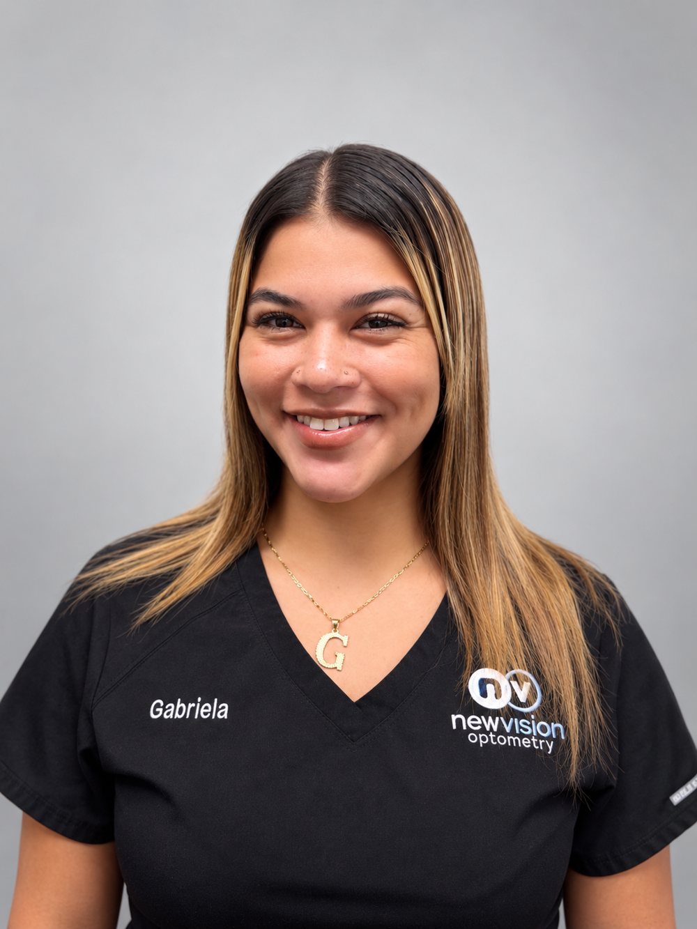 Portrait of Gabriela, Optometric Technician, in black New Vision Optometry scrubs
