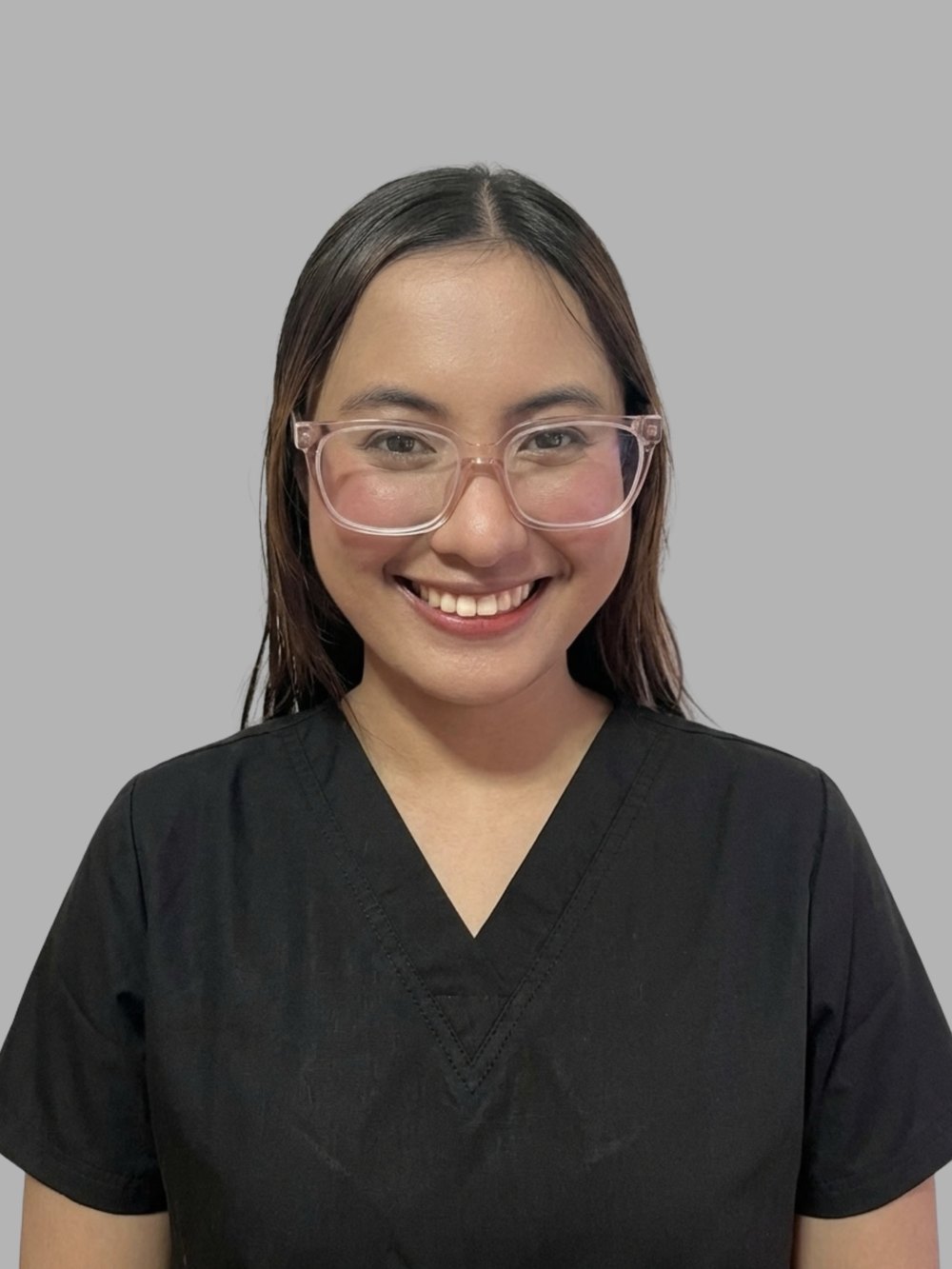 Portrait of Lia, Licensed Pharmacist (Philippines) and Clinical Care Coordinator, in black scrubs