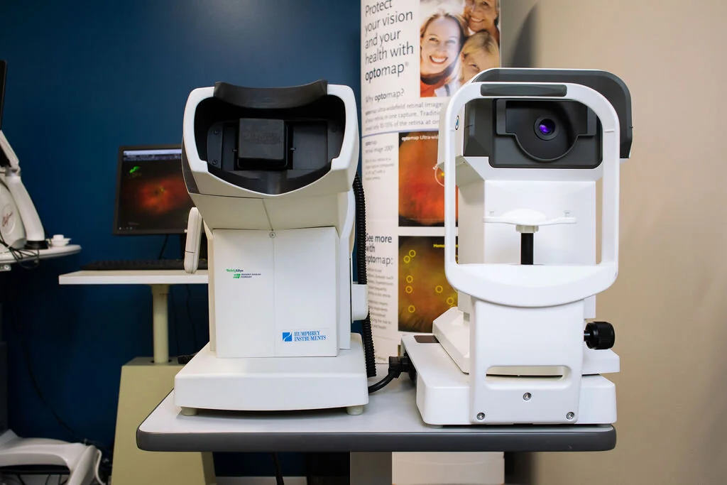 An imaging instrument on its stand in the exam area at New Vision Optometry