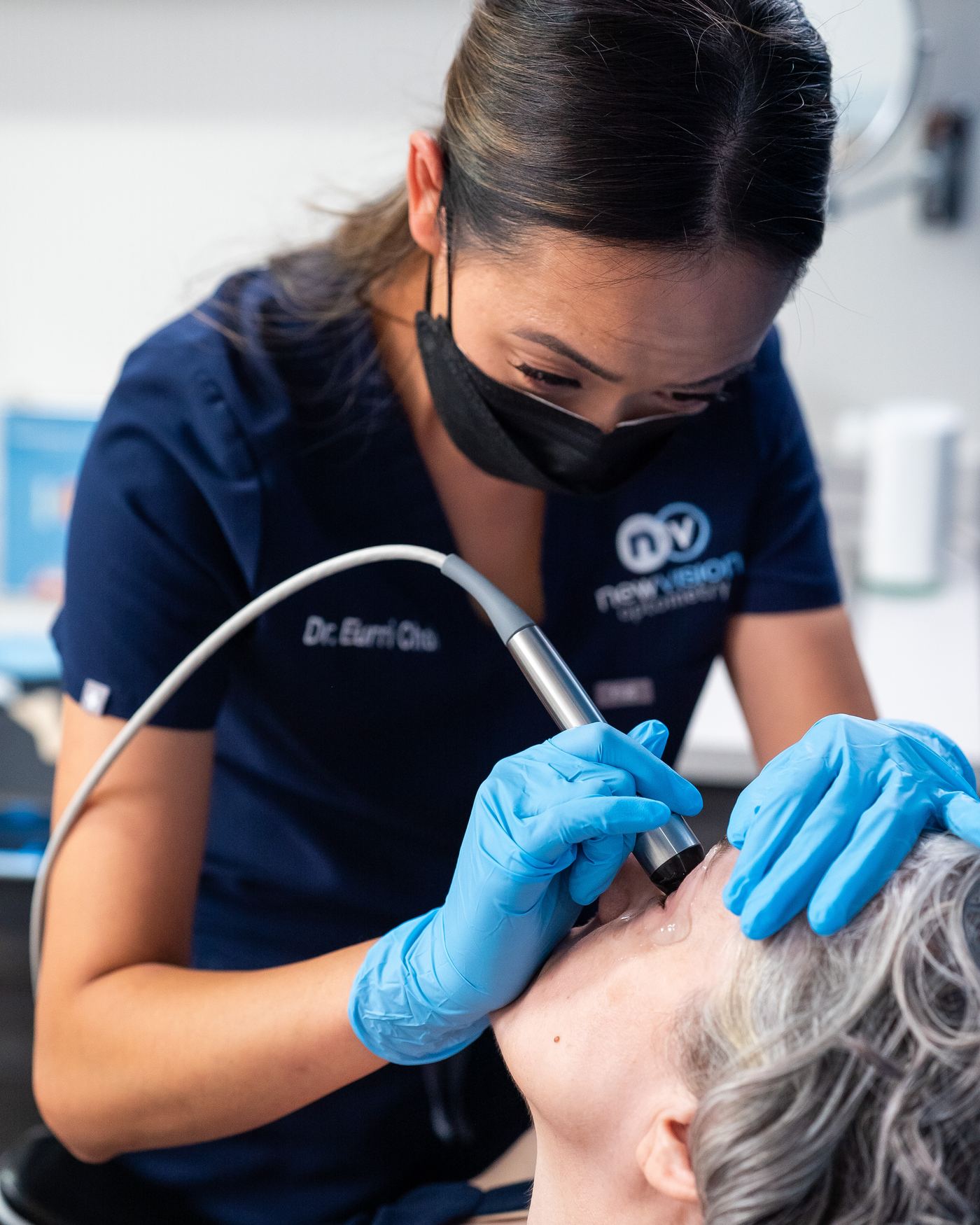 Dr. Choi guiding the Forma-I radiofrequency handpiece along a patient's eyelid at New Vision Optometry